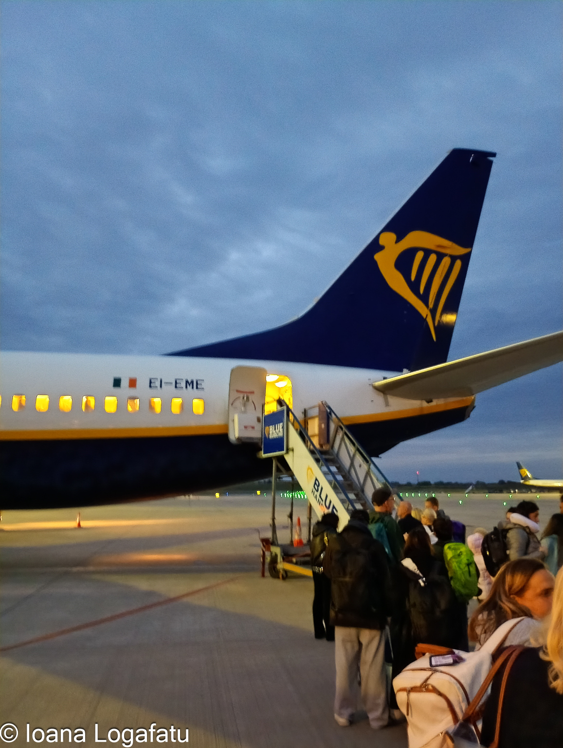 Passengers boarding a Ryanair flight at dusk